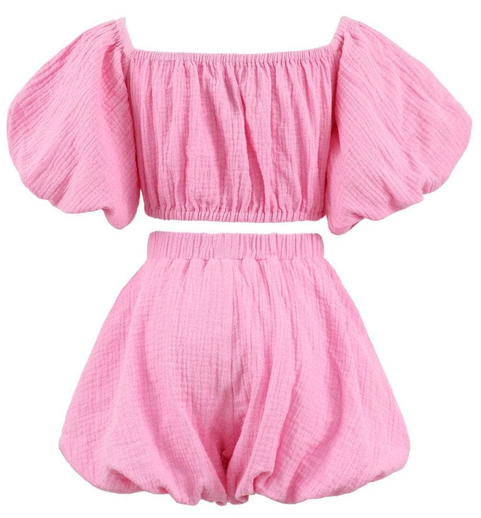 girls Pink off-shoulder top and shorts set on a white background