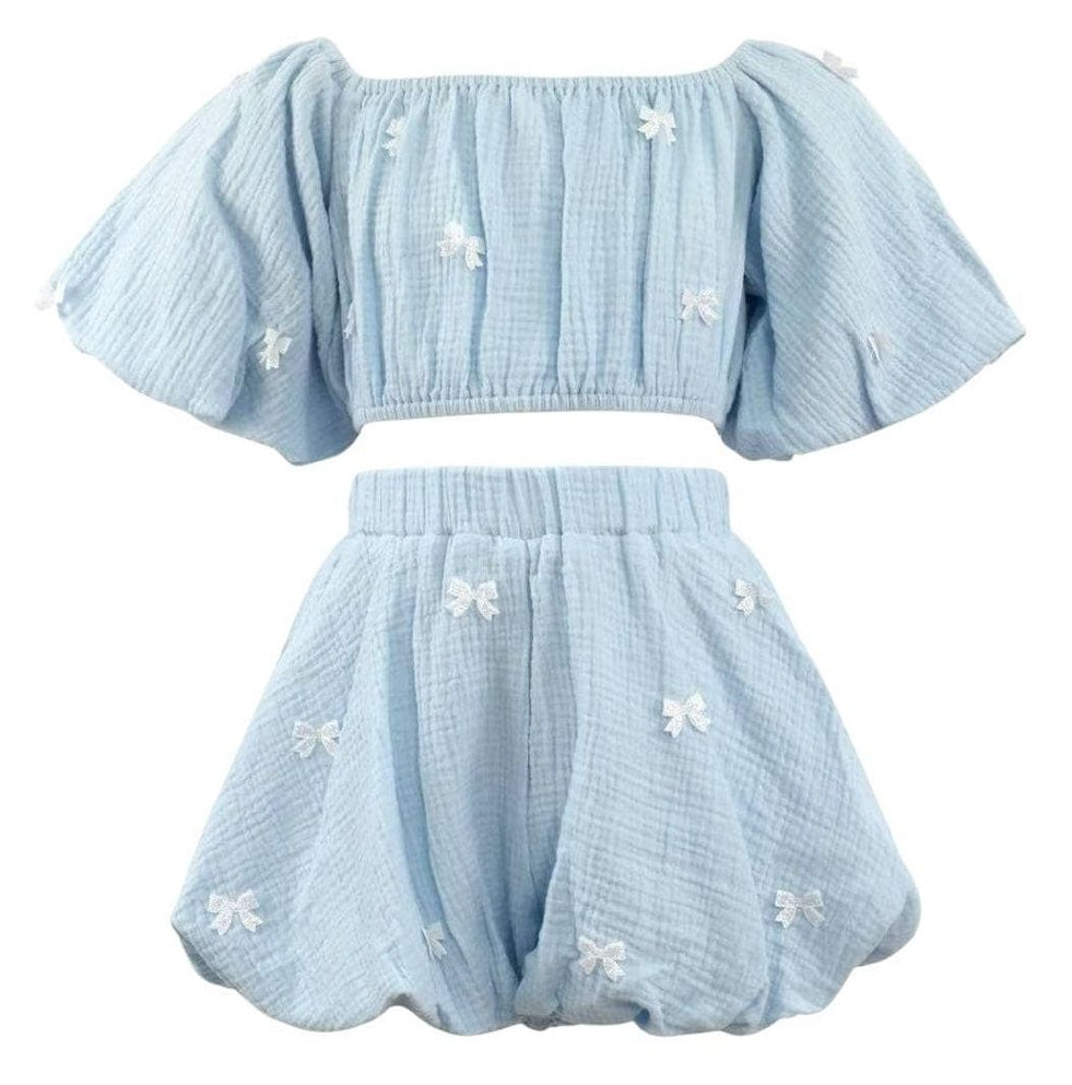 girls Light blue checkered outfit with bow details on a white background