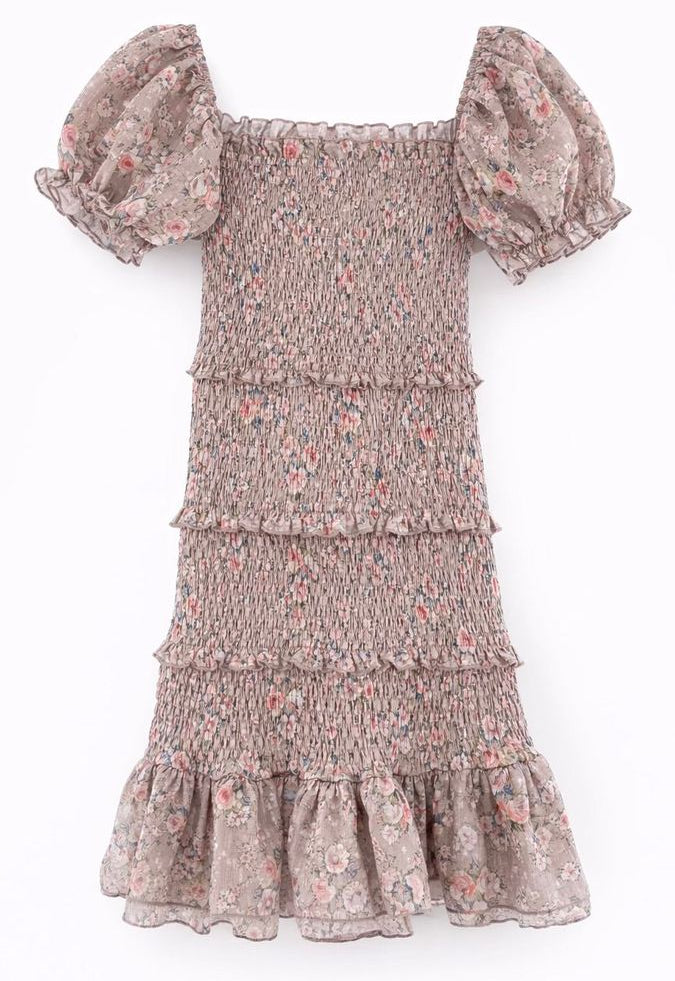 A smocked tiered dress with puff sleeves and a ruffled hem, featuring a dusty rose and pink floral pattern on a light taupe background.
