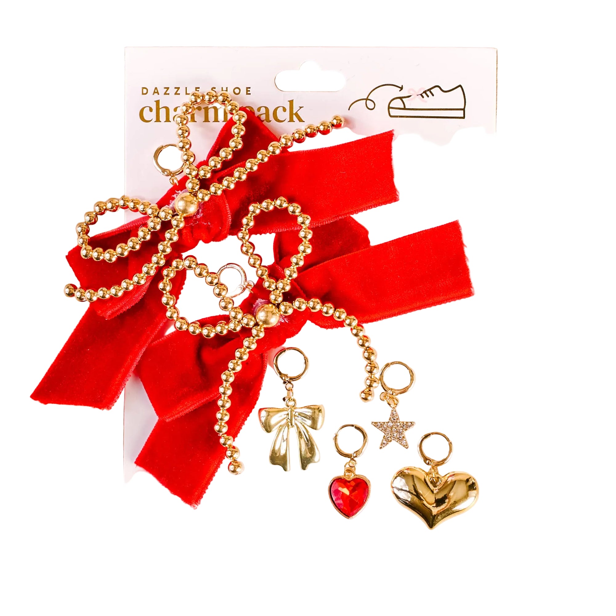Shoe charm pack with red bows and gold charms on a beige background