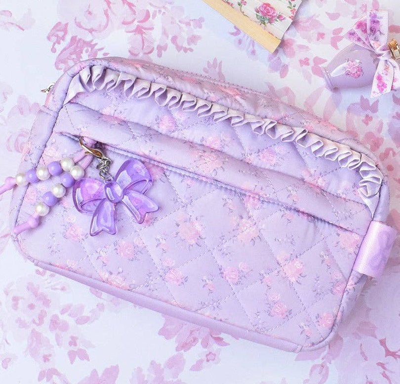 Pastel purple pouch with decorative elements on a floral background