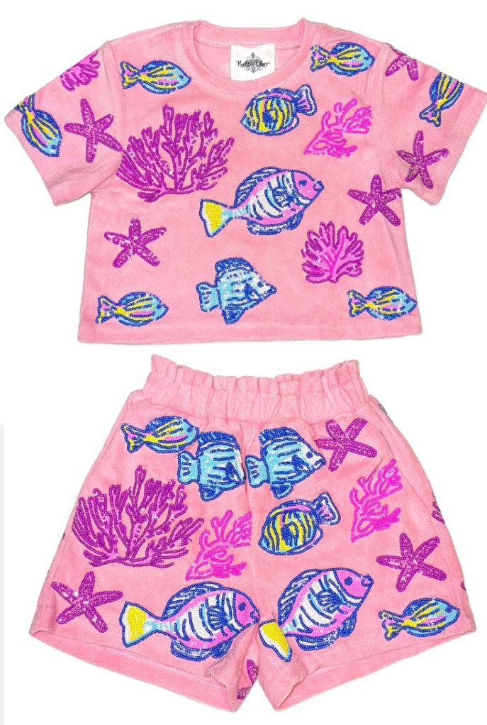 Pink children's outfit with fish and coral pattern on a white background