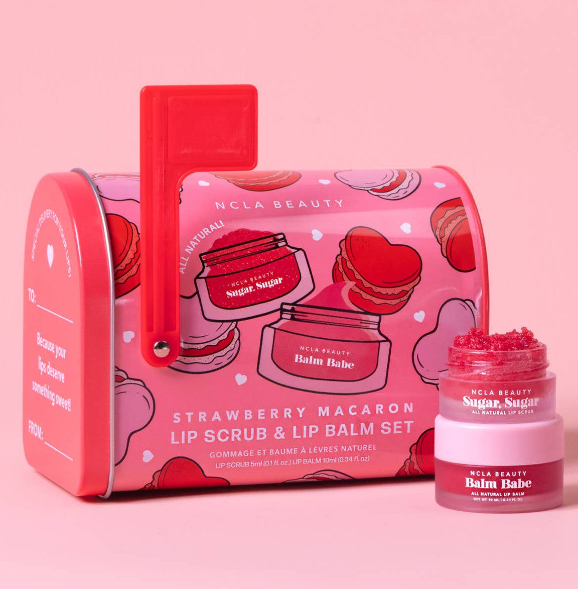 Pink lip scrub and lip balm set with a decorative box on a pink background