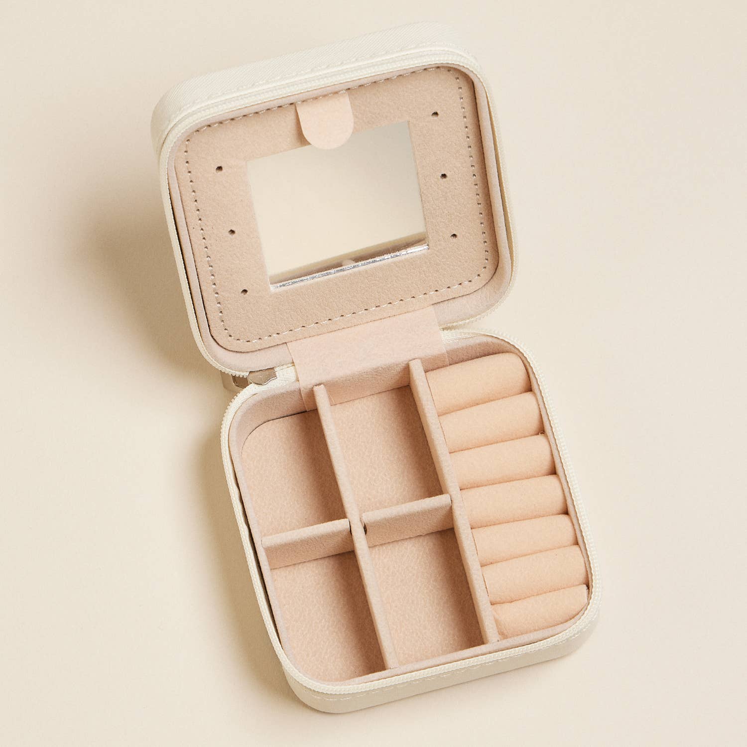 Beige jewelry box with mirror on a beige background