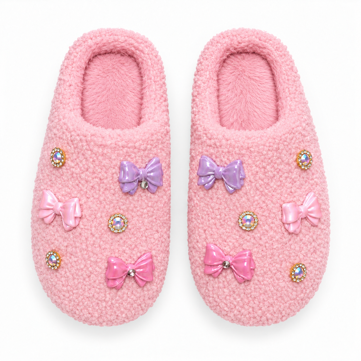 Pair of textured pink girls slippers decorated with glossy bubblegum pink, baby pink and lavender bow charms and iridescent jewel accents.
