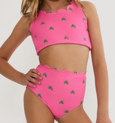 Girl wearing the Beach Riot Kids Little Madison Bea Set in Flamingo Palm Fronds featuring an embroidered palm tree two-piece swimsuit.