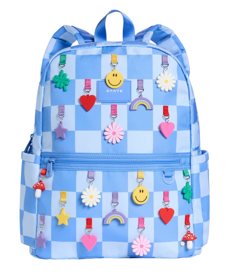 Angled view of the STATE Bags Blue Check backpack showcasing two spacious compartments, front organization pocket, and playful charm-inspired print.