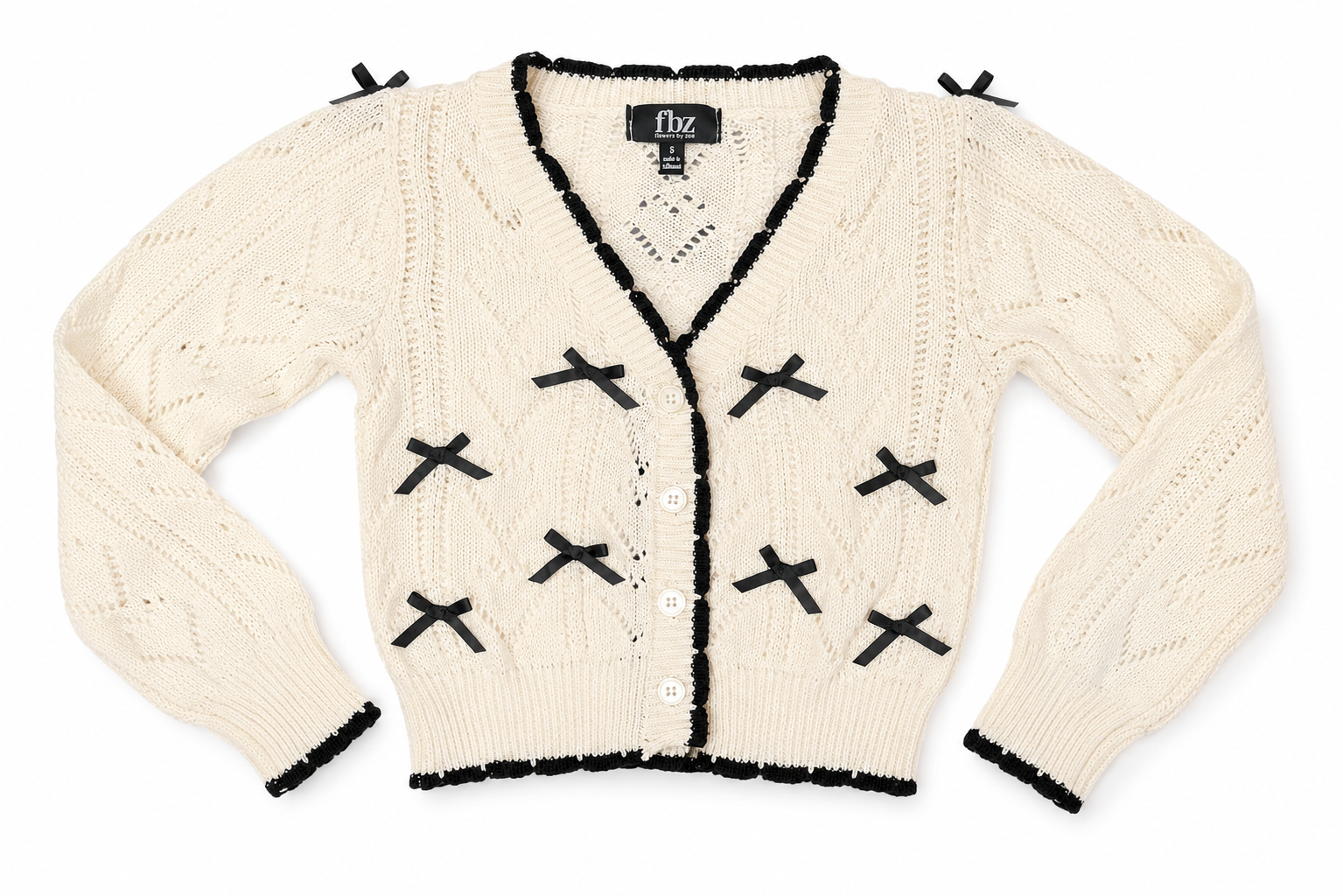 Close-up of Flowers by Zoe FBZ ivory knit cardigan with black bow and trim details