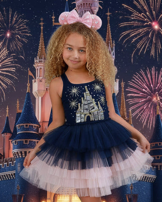 Close-up of a girls' navy and pink princess castle dress showing intricate jeweled and sequin detailing across the castle-inspired bodice.
