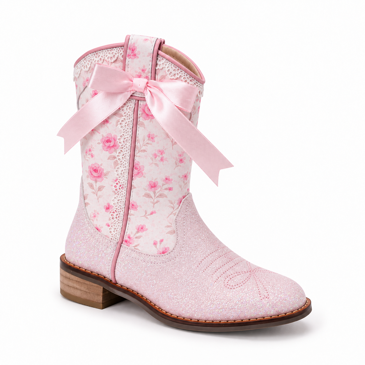 A pink western-style boot with a glittery pink foot, floral print shaft, and a large light pink ribbon bow tied at the back, shown on a white background.