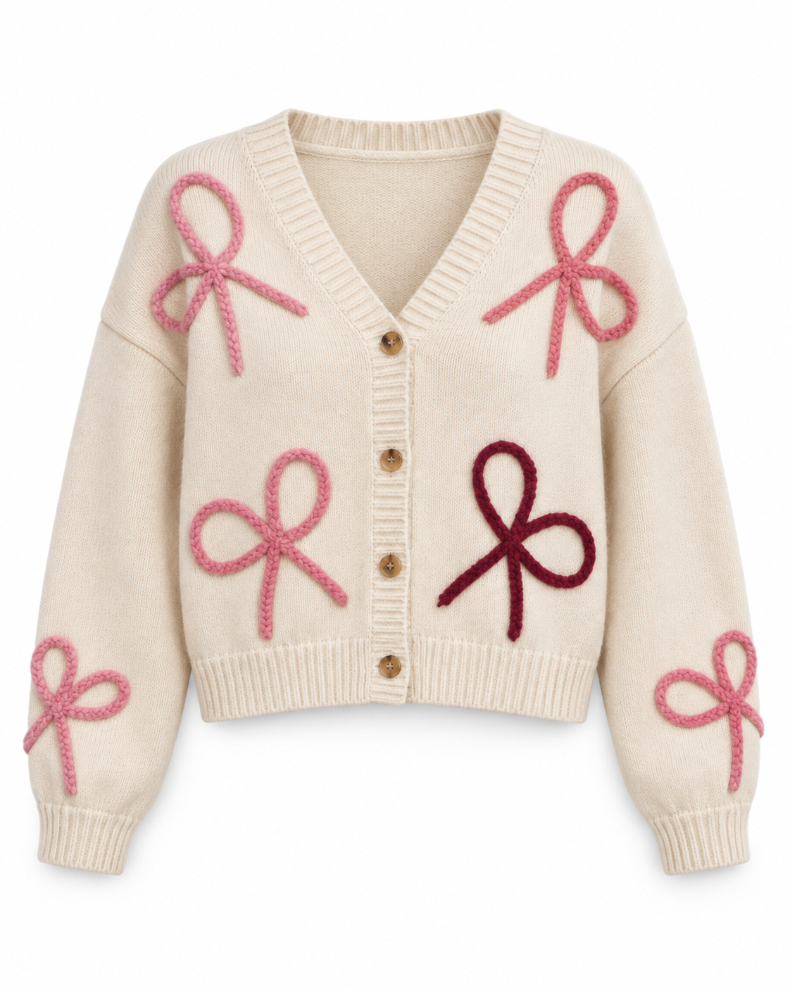 A cream-colored knit cardigan sweater featuring large, raised bow motifs in pink and burgundy across the front and sleeves, with a button-up front.