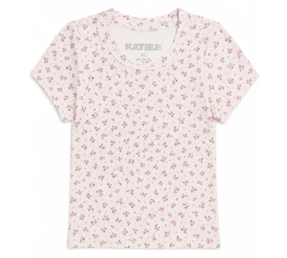 A short-sleeve crewneck t-shirt by KatieJ, featuring a delicate all-over pink floral print on a white background.