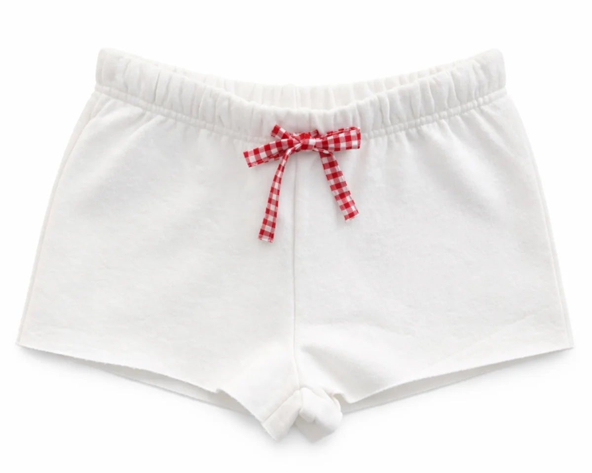 katiej white knit shorts with a red gingham bow tie at the waist on a white background