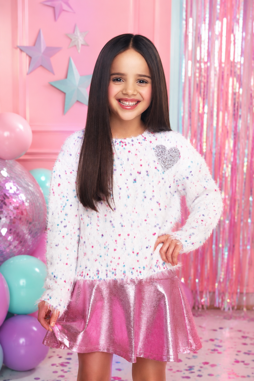 Soft white girls sweater with colorful speckles and silver sequin heart paired with a shimmering pink skirt.