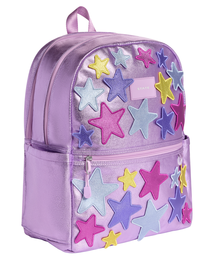 Angled view of the STATE Bags 3D Stars Metallic Purple backpack showcasing spacious double compartments and colorful raised star details.