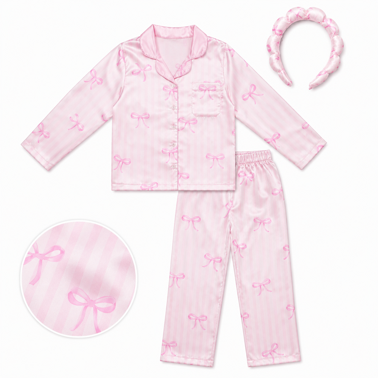 A pink pajama set for a child, featuring a long-sleeve button-up top and matching pants with an allover bow print, shown on a white background with a matching headband and a circular detail inset.