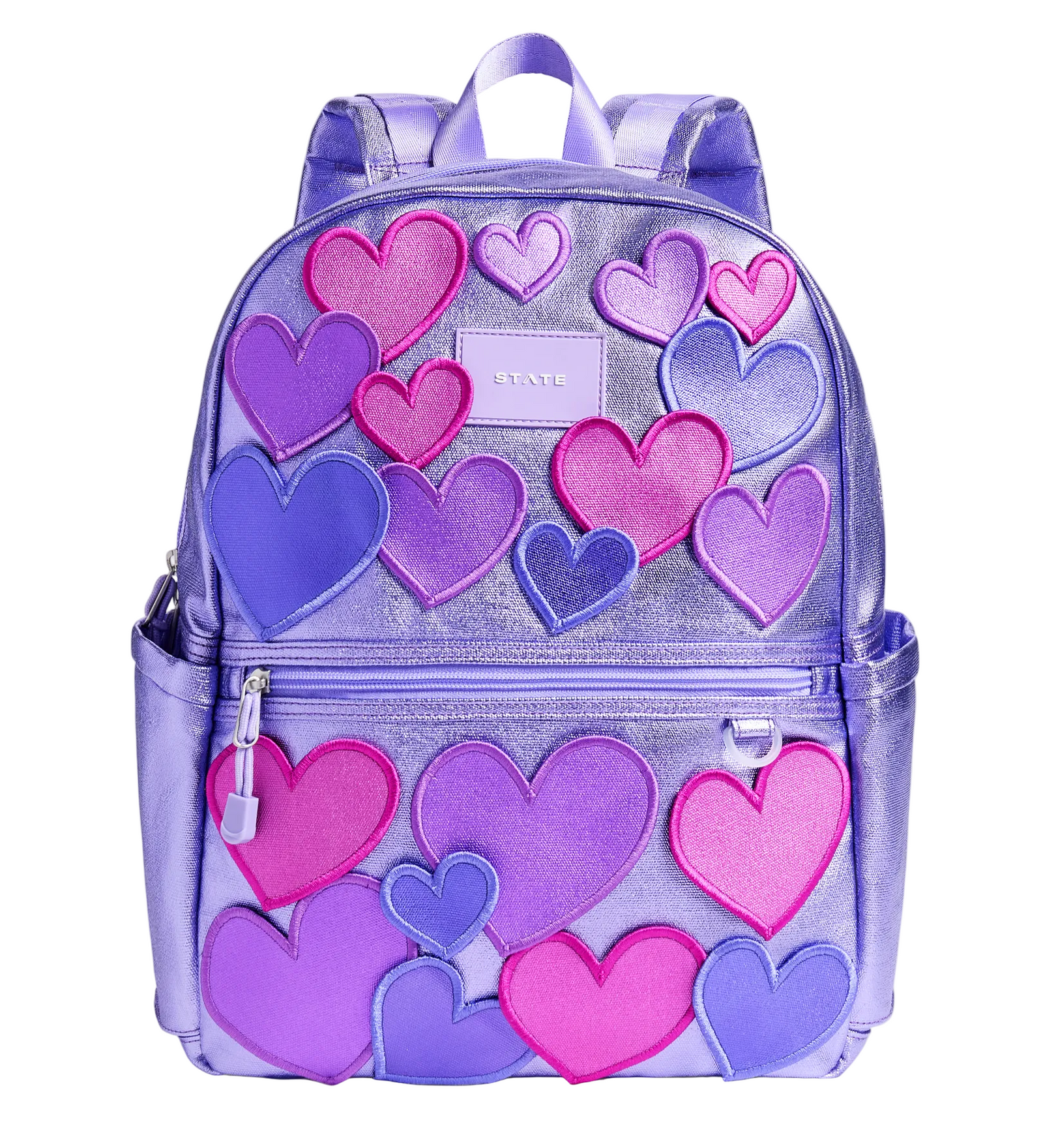 Front view of the STATE Bags Kane Double Pocket Backpack in 3D Hearts featuring metallic lavender fabric with dimensional pink and purple heart appliqués.