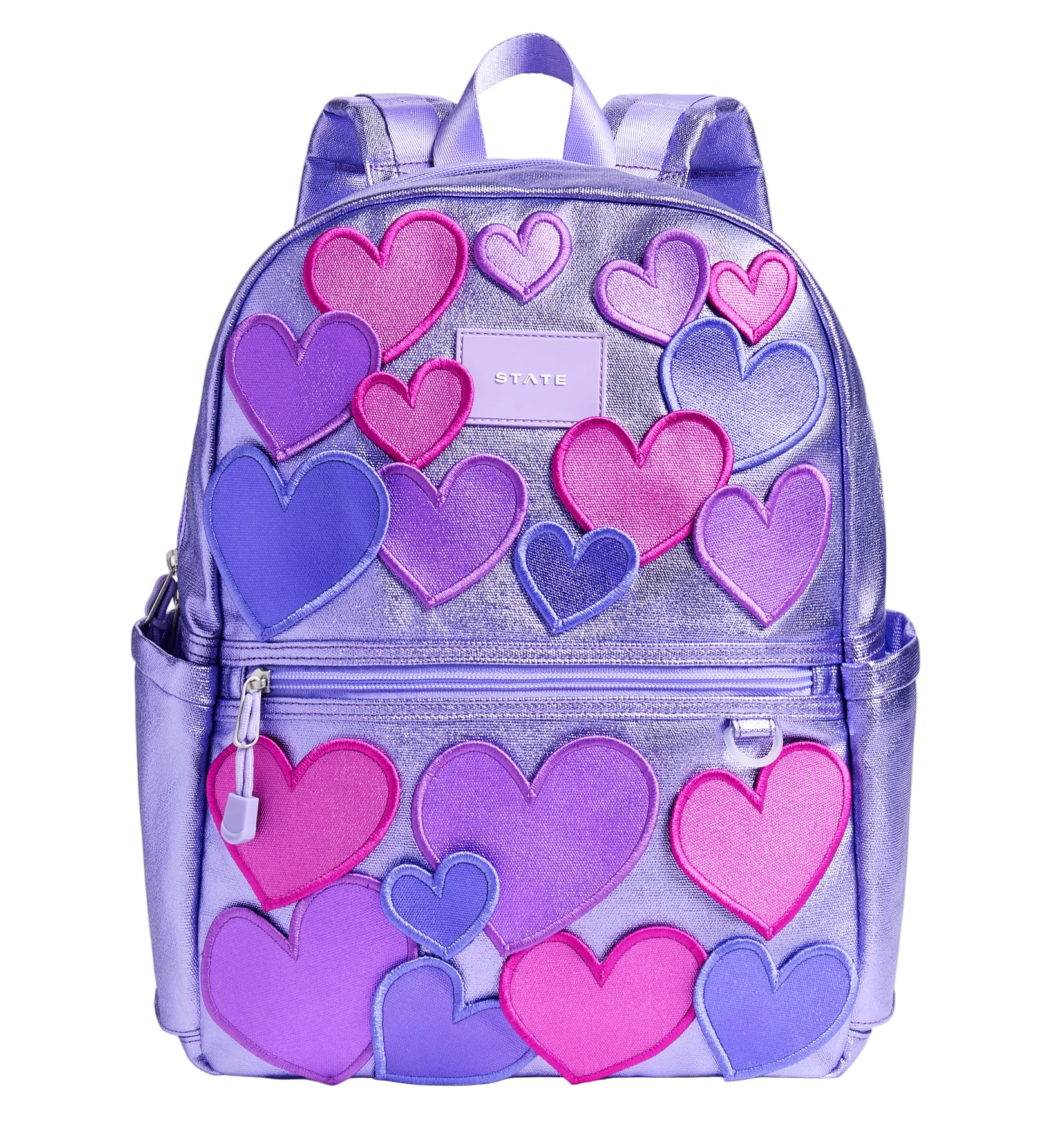 Front view of the STATE Bags Kane Double Pocket Backpack in 3D Hearts featuring metallic lavender fabric with dimensional pink and purple heart appliqués.