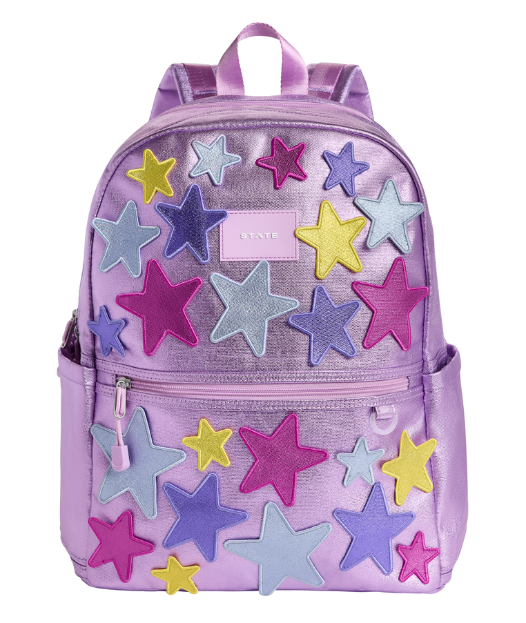 Front view of the STATE Bags Kane Double Pocket Backpack in Metallic Purple featuring colorful dimensional 3D star appliqués on a shimmering lavender finish.
