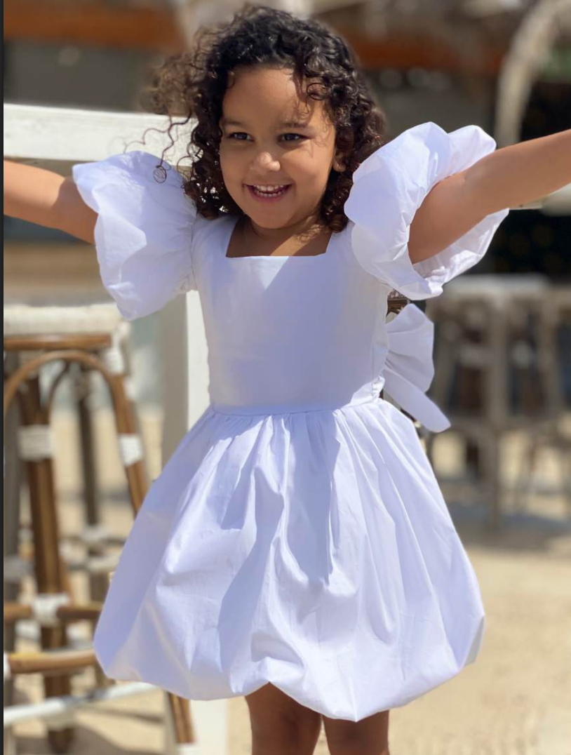 girls white dress with bow tie in the back