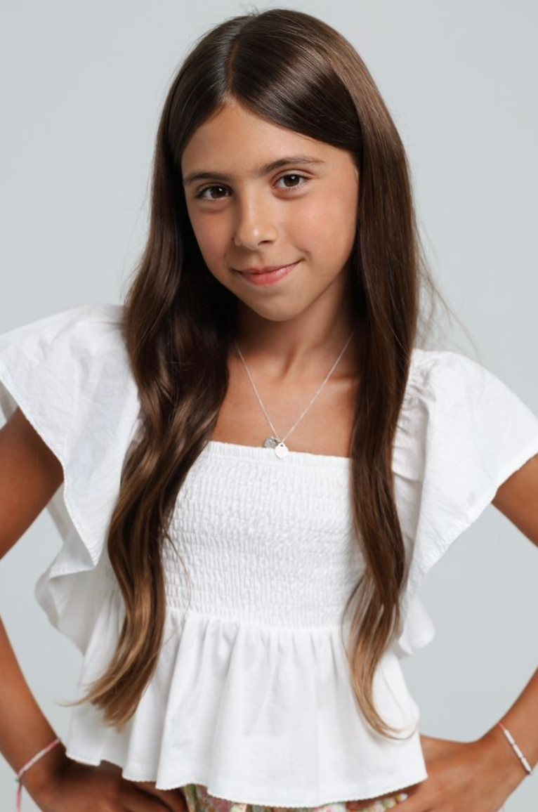 tween girl wearing a white blouse