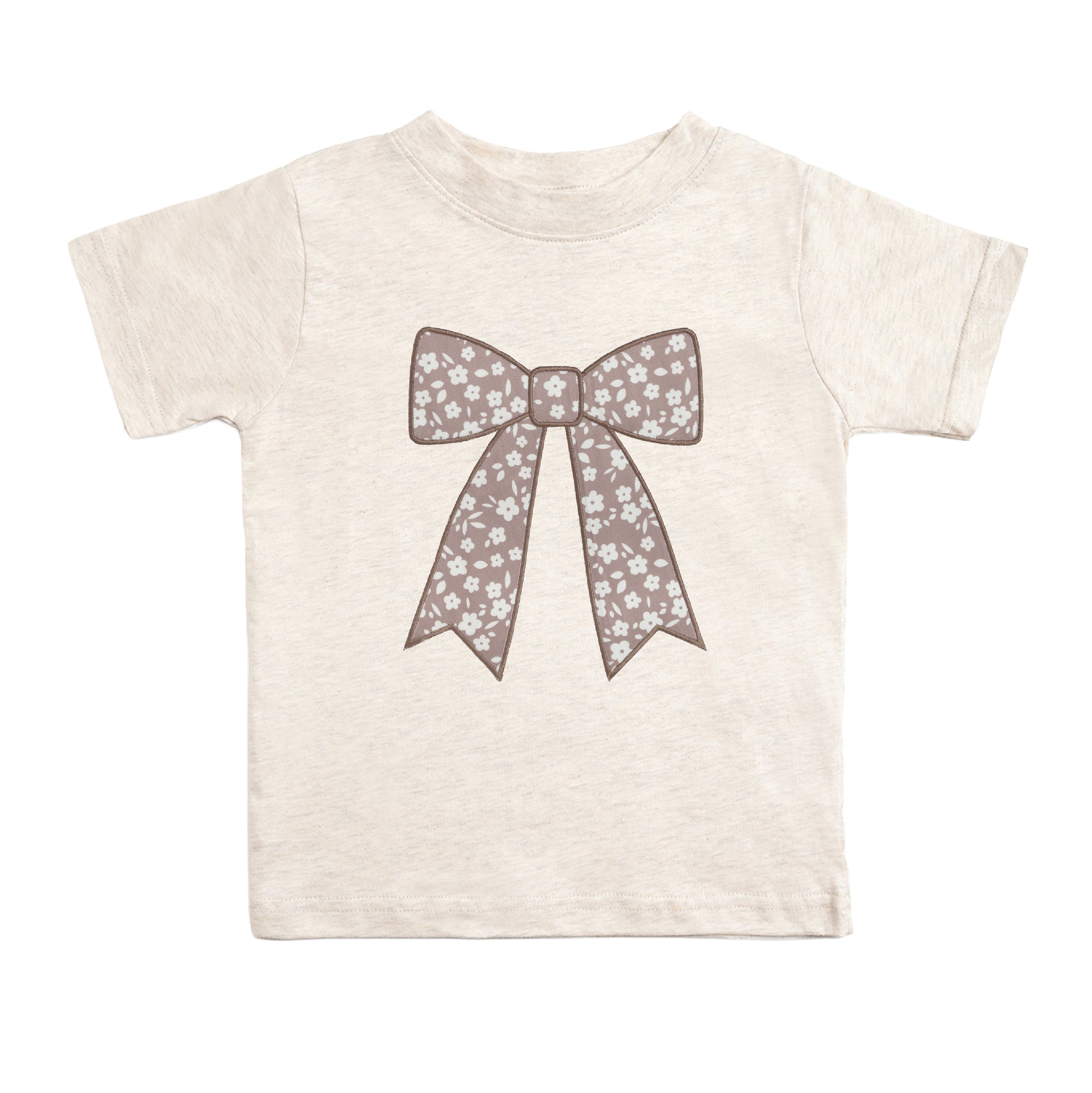 Little girl wearing the Sweet Wink Mocha Floral Bow Tee paired with the matching floral skort for a fall boutique outfit.
