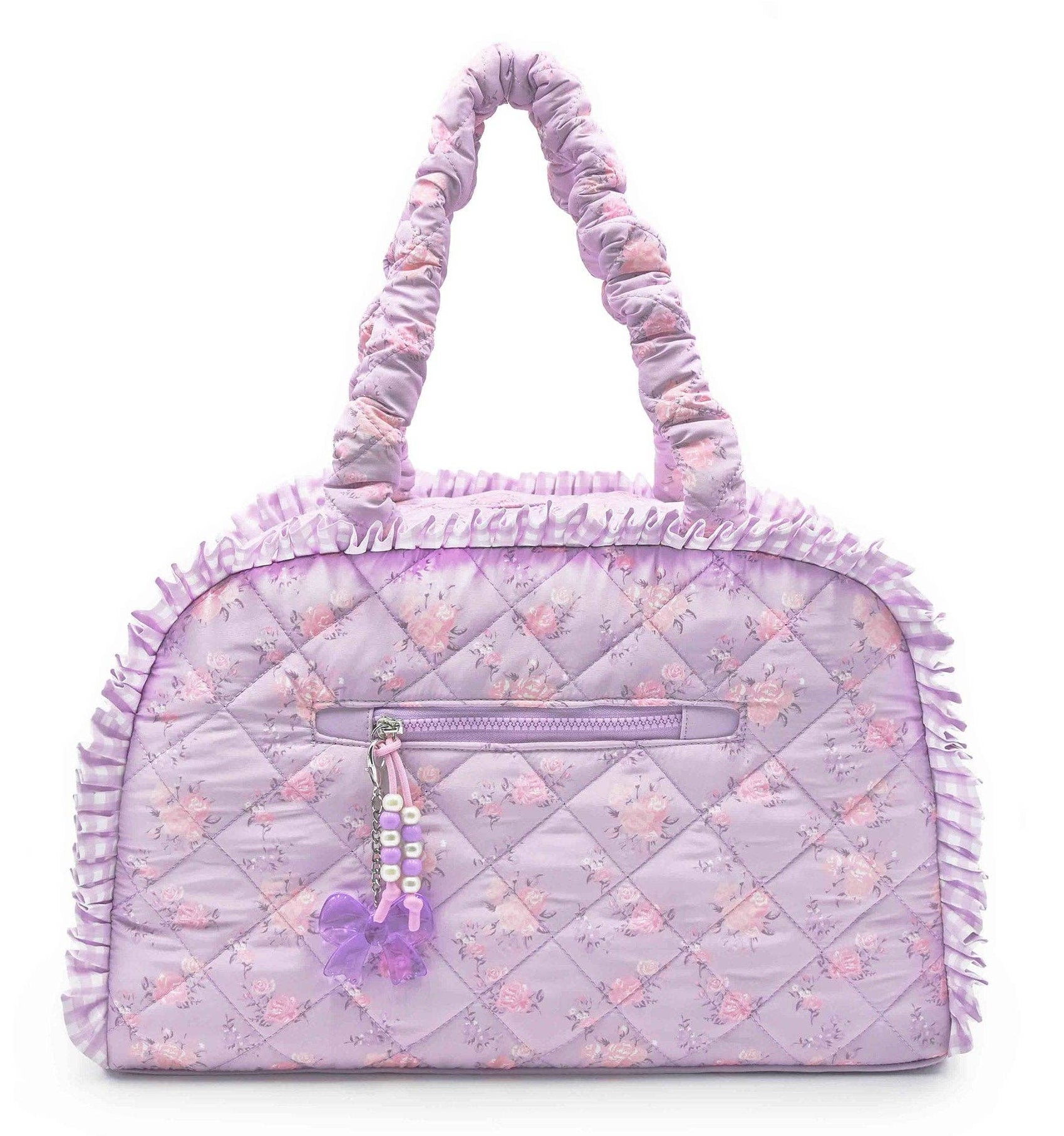 Quilted handbag with floral pattern and pom-pom detail on a white background
