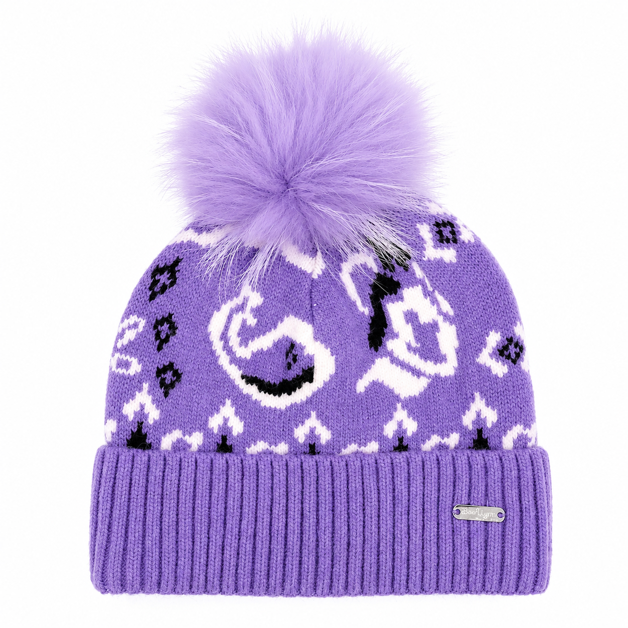 A purple knit beanie hat with a large fluffy purple pom-pom on top, featuring white and black geometric and animal-like knit patterns, a ribbed cuff, and a small silver brand tag on the side.