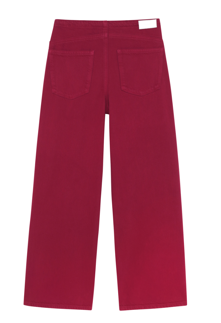 A pair of wide-leg jeans in a deep magenta red, shown from the back with two back pockets, on a solid white background.