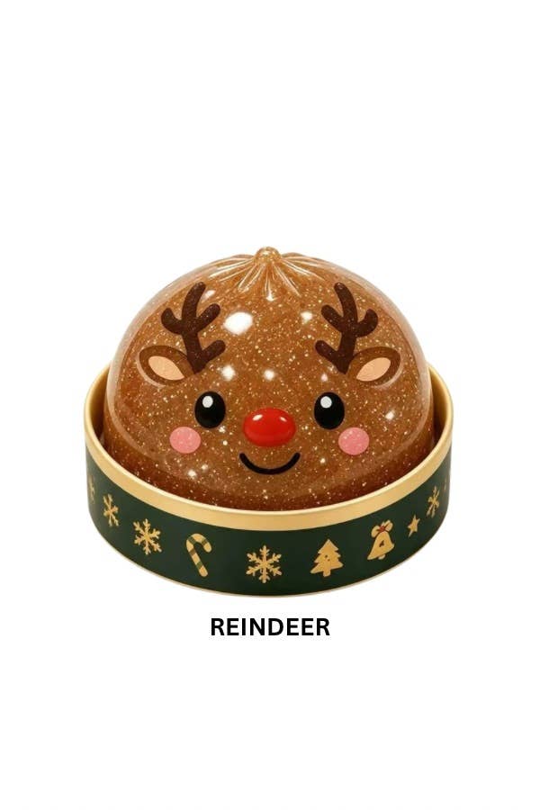 A festive reindeer mystery holiday dumpling squishy with a glittery brown dome lid shaped like a reindeer face, featuring dark brown antlers, a red nose, pink cheeks, and a dark green band decorated with gold holiday icons. The word 'REINDEER' is printed below on a plain white background.