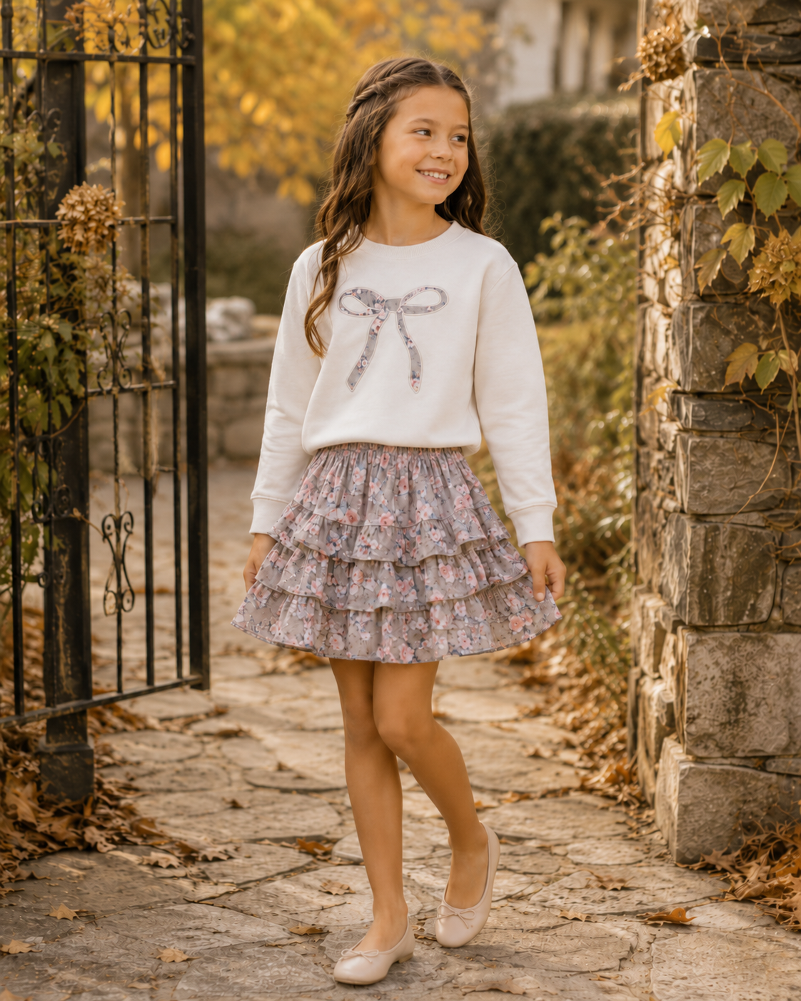 Girl modeling Summer Loving ivory sweatshirt with floral bow and matching Autumn Rose Floral tiered skirt