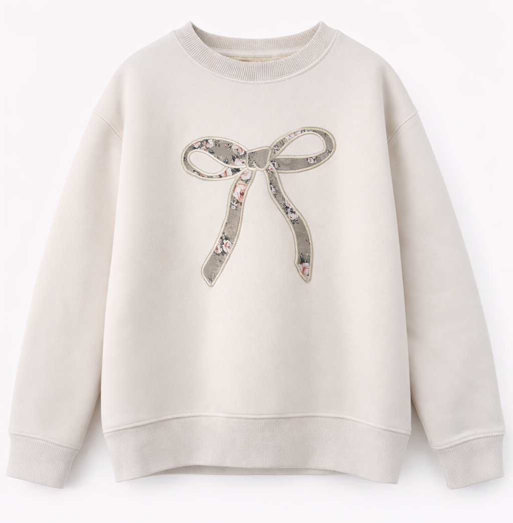 Close-up of floral bow applique on ivory girls sweatshirt