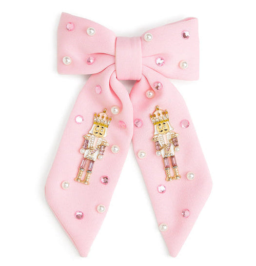 Pink Christmas bow hair clip with nutcracker, pearl and pink gemstone embellishments