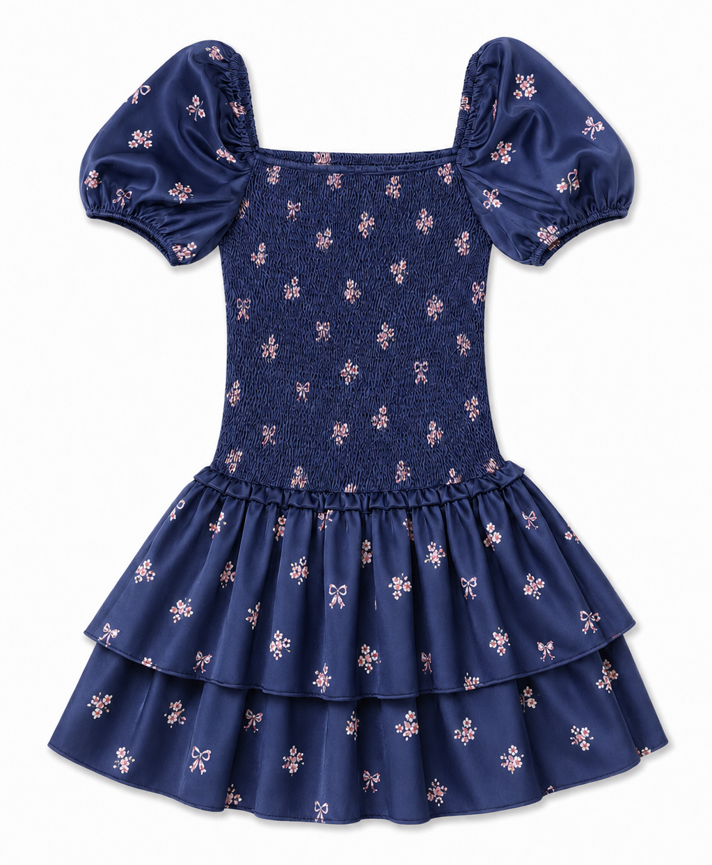 A navy blue tiered dress with puff sleeves and a smocked bodice, decorated with a small pink and white floral pattern, shown against a plain white background.