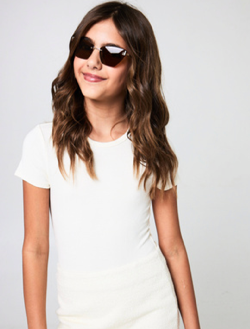 Tween girl wearing the Gold Rush NYC Bailey cream ribbed short sleeve bodysuit.