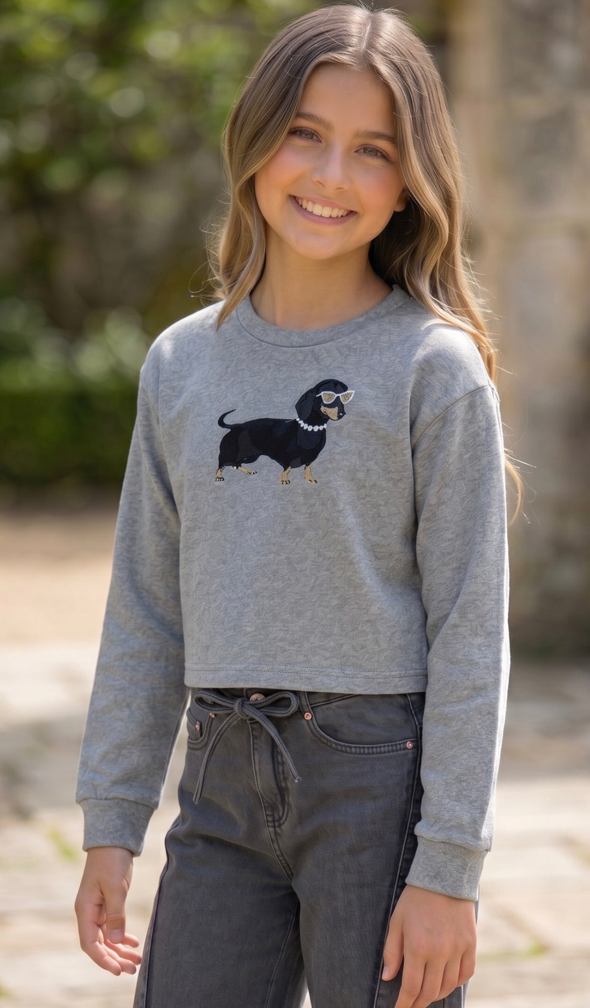 tween girl in grey sweatshirt with dog by flowers by zoe 