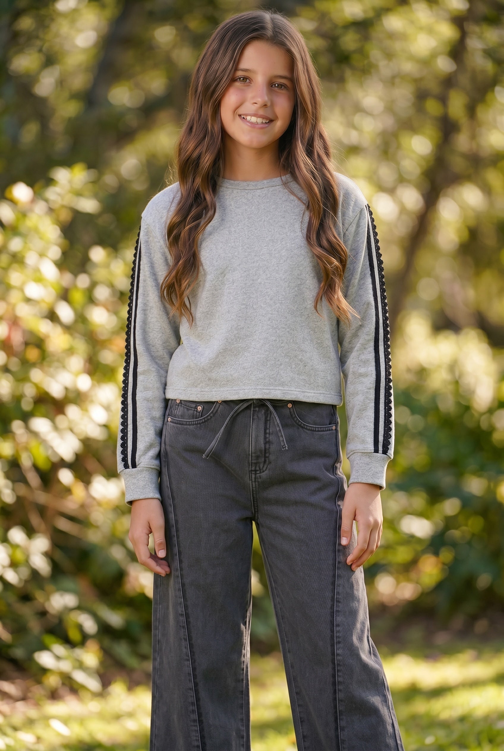 tween girl wearing a FBZ sweatshirt in grey with black wide leg jeans